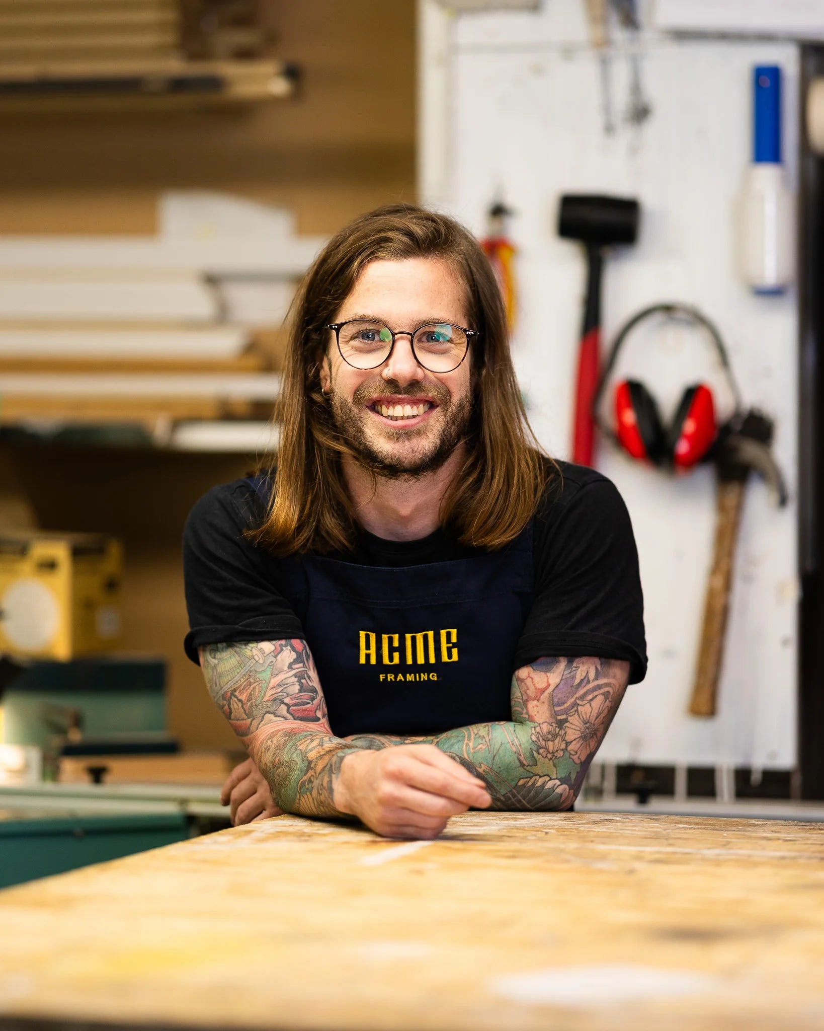 Portrait of Alex Bebbington in the ACME Framing workshop, specialising in bespoke picture framing and handcrafted one-of-a-kind frames.