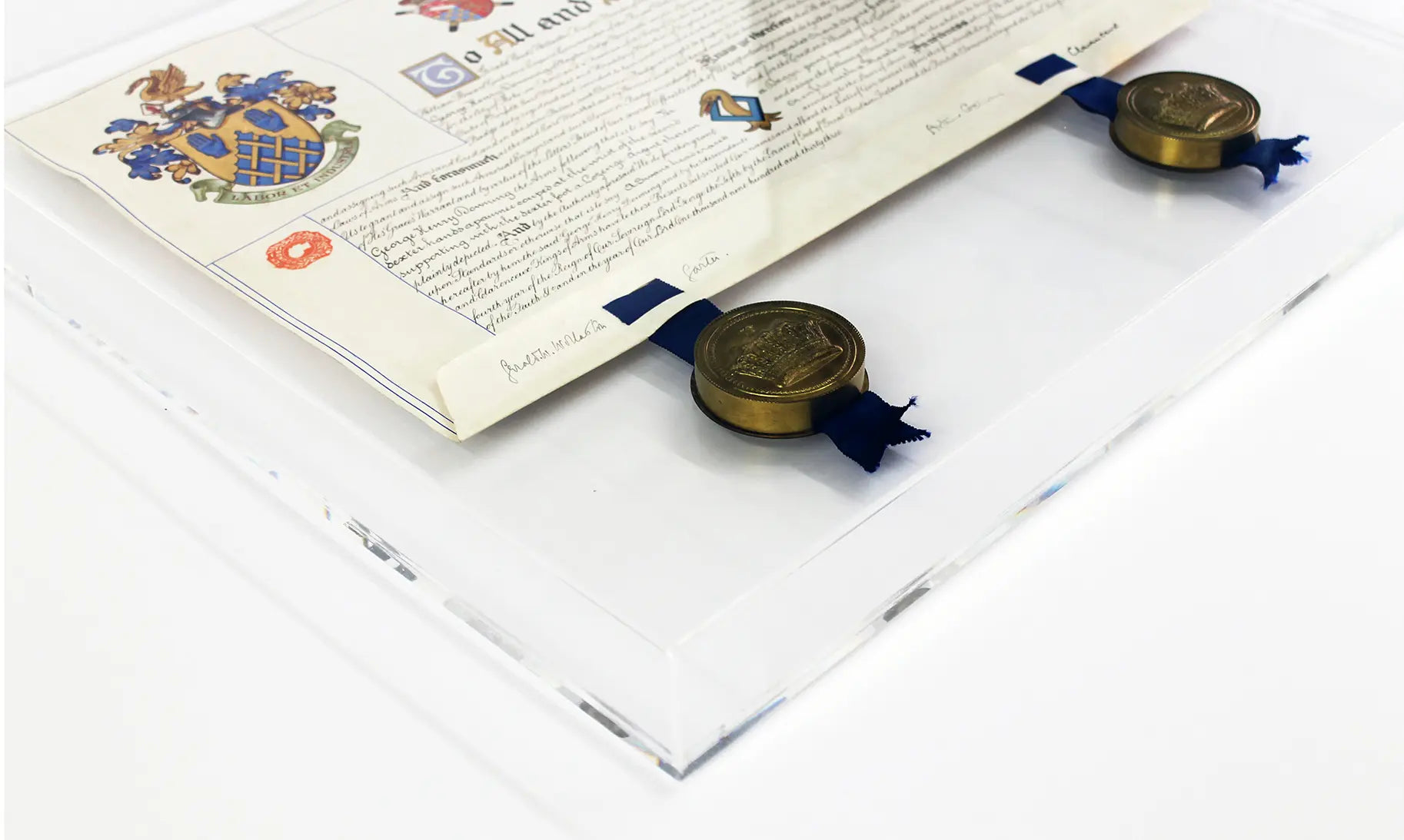 Close-up detail of a bespoke clear acrylic box frame displaying a historic document with wax seals, showcasing precision conservation mounting and handcrafted acrylic construction.