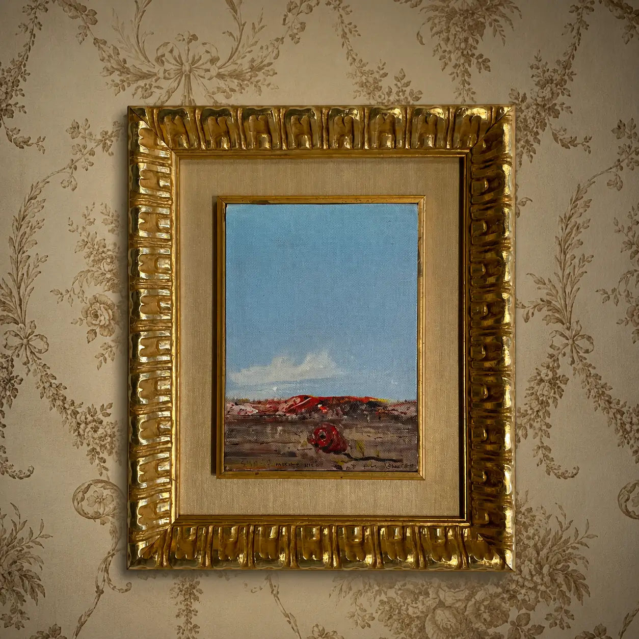 Hand-restored antique gilded picture frame with a custom fabric mat surrounding a small landscape painting, showcasing custom finishes and frame restoration craftsmanship.