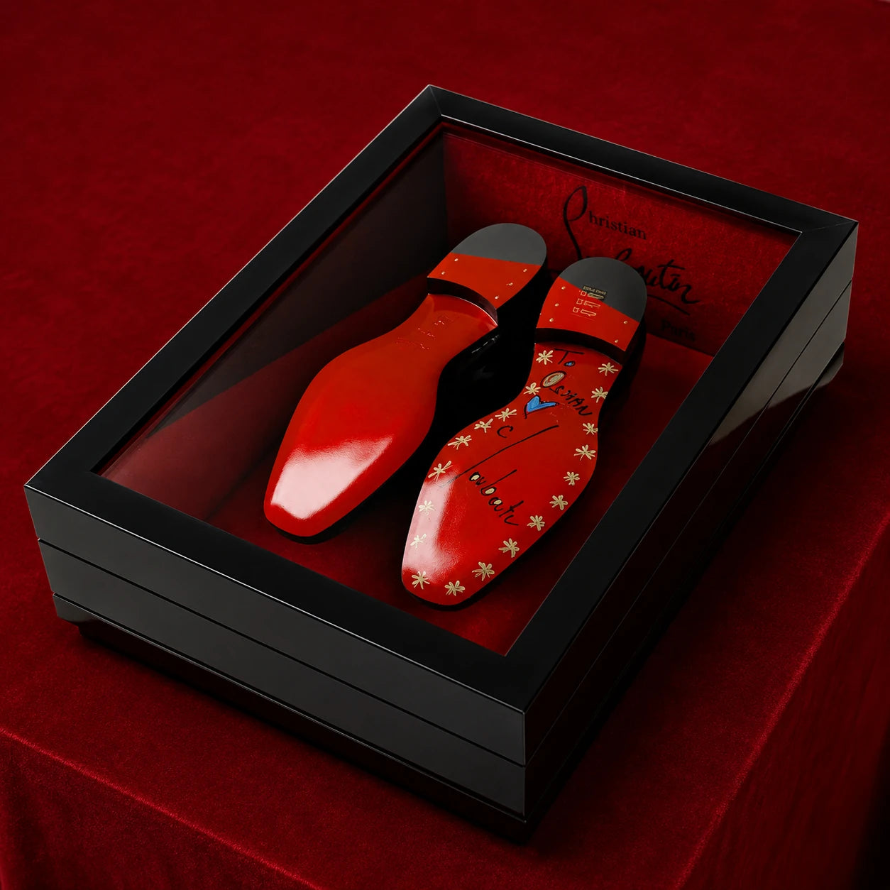 Luxury custom framed display case with black lacquer finish and red velvet interior, handcrafted to showcase Christian Louboutin shoes using bespoke finishes and museum-quality presentation.