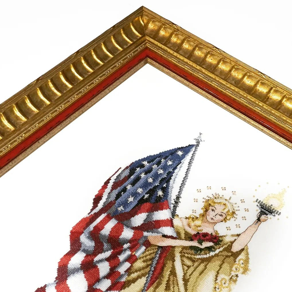Close-up detail of a handcrafted gold leaf picture frame corner with red inner slip, showcasing traditional gilded finish, carved moulding and fine craftsmanship.