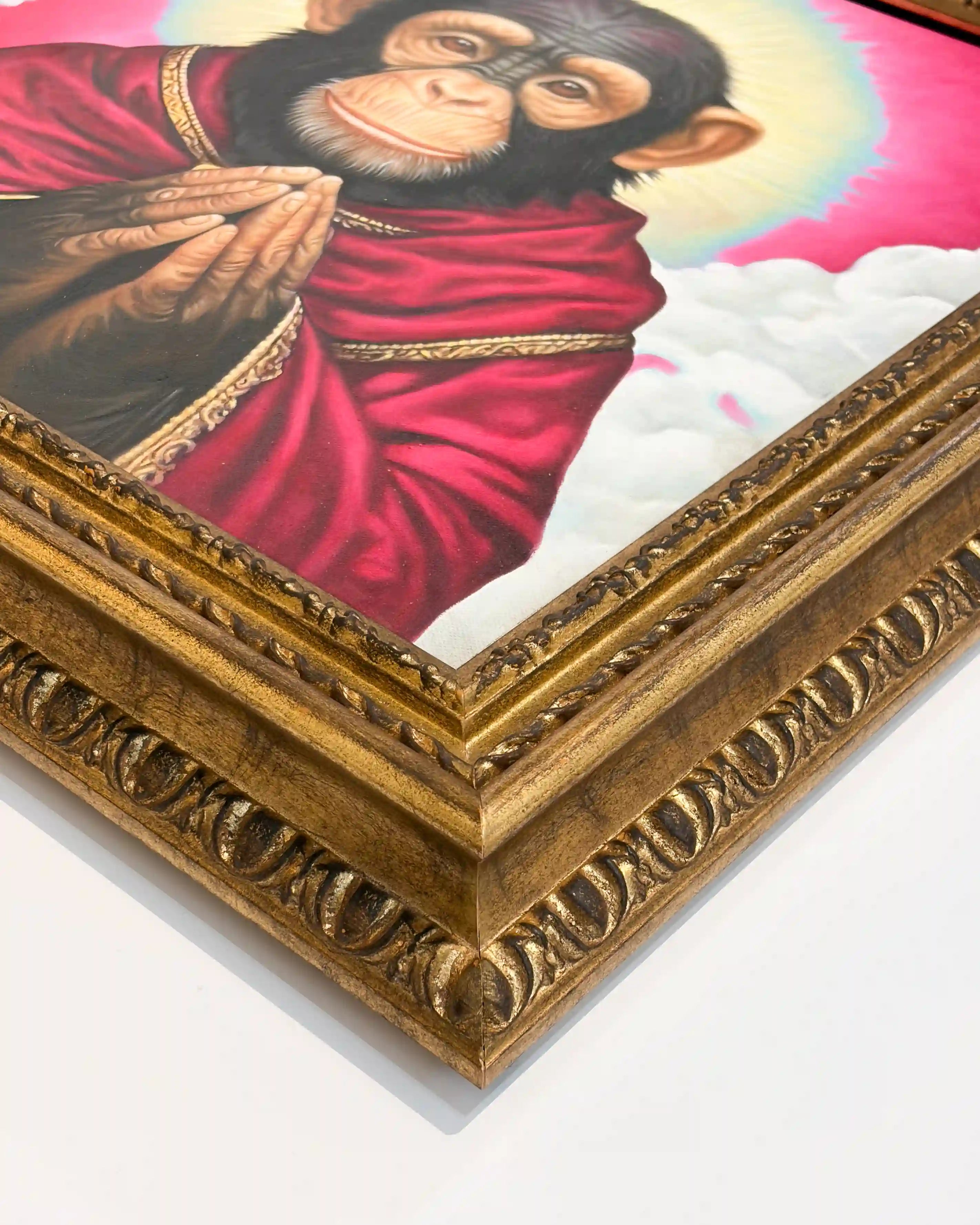 Close-up of a handcrafted ornate antique gold picture frame corner, showcasing intricate carved moulding, gilded detailing, precision corner joinery and contemporary chimpanzee artwork.