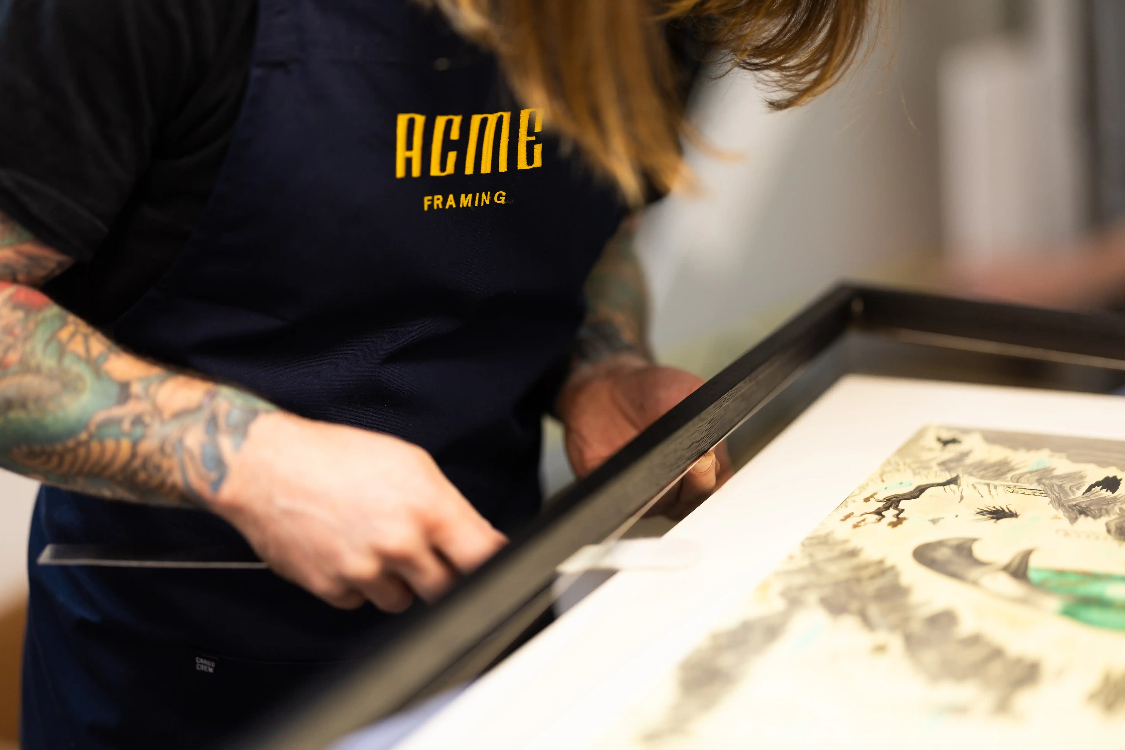 ACME Framing artisan hand-assembling a bespoke picture frame for custom framing in the Sydney workshop using traditional craftsmanship and precision techniques.