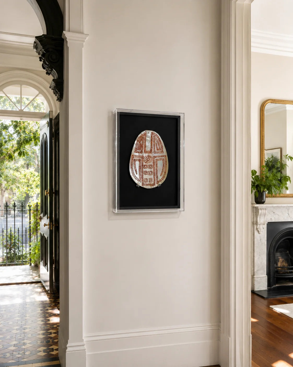 Handcrafted clear acrylic box frame displaying a carved mother-of-pearl artwork on a black mount, styled in a Victorian terrace hallway to showcase bespoke framing craftsmanship.
