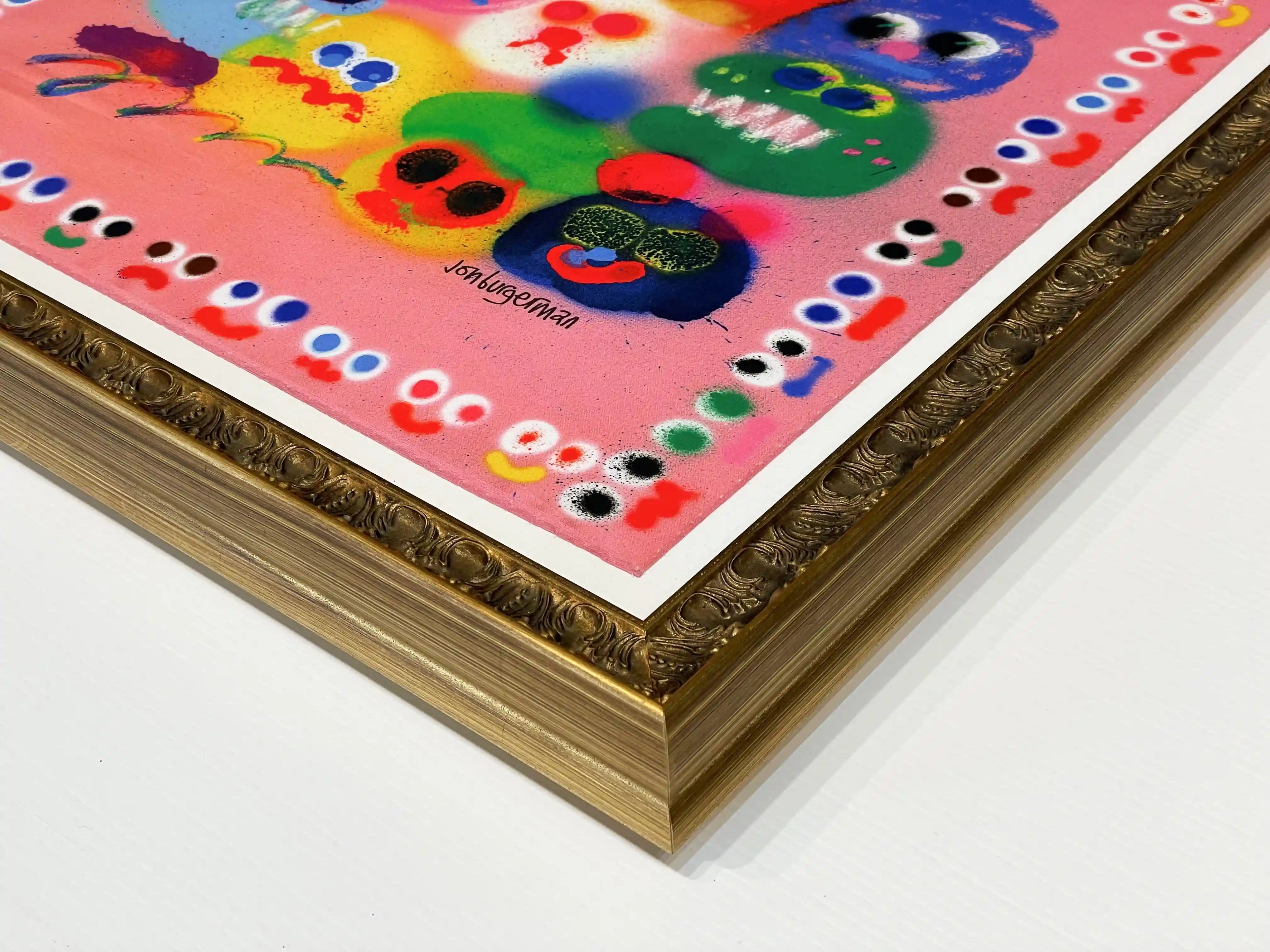 Close-up detail of a bespoke antique gold picture frame surrounding a colourful Jon Burgerman artwork, highlighting the ornate moulding profile, crisp white mount, precision corner joinery and premium custom framing craftsmanship.